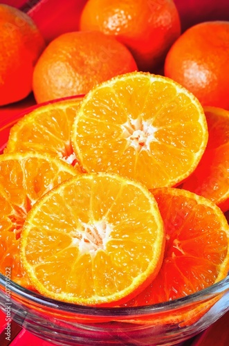 Concept with orange fresh fruits. Tangerines in a glass bowl.