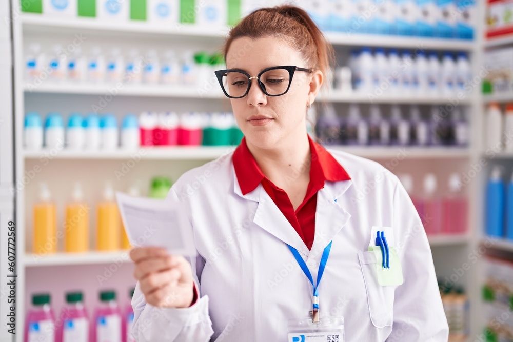 Young beautiful plus size woman pharmacist reading prescription at pharmacy