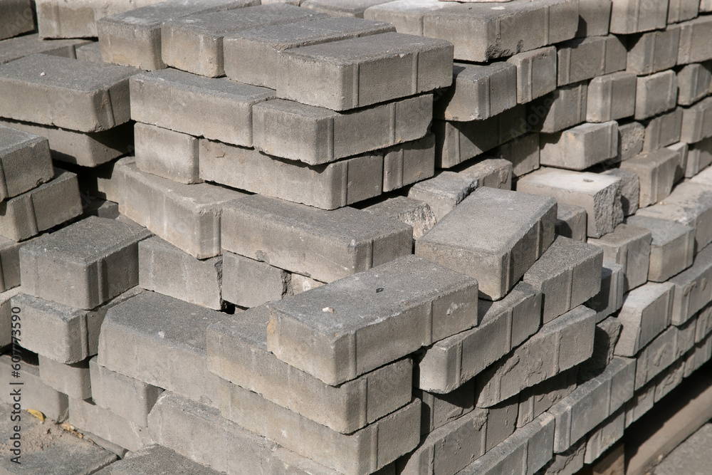 Old square paving slabs laid out in vertical rows. Processing of materials, recycling and storage of bricks. Old square paving slabs laid out in vertical rows. Processing of materials, recycling and storage of bricks.