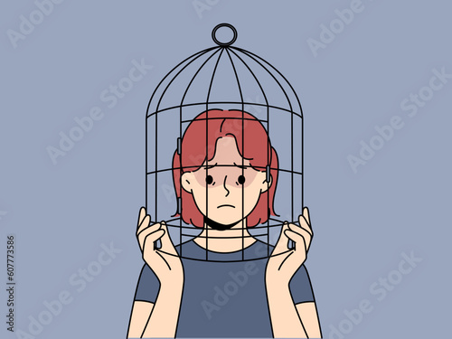 Unhappy teenager girl with head in birdcage suffer from discrimination and lack of freedom. Upset teen child locked in cage struggle with psychological problems. Vector illustration. 