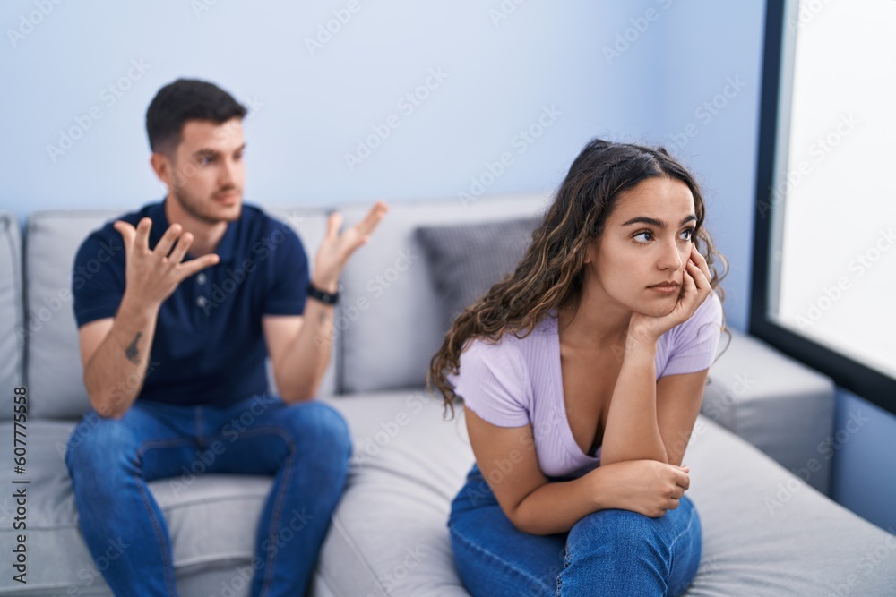 Young hispanic couple arguing sitting on sofa at home Young hispanic couple arguing sitting on sofa at home