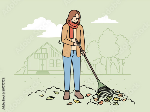 Woman with rake gathering leaves in street in autumn. Female in outerwear sweeping fallen leaves in fall. Vector illustration.  photo