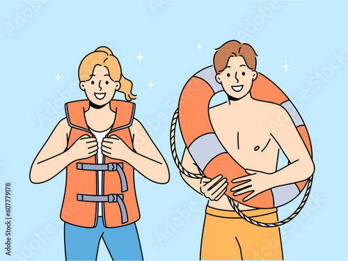 Smiling people in lifejacket and lifebuoy working on seashore. Happy lifeguards in inflatable vest and ring. Life saving and occupation. Vector illustration. 