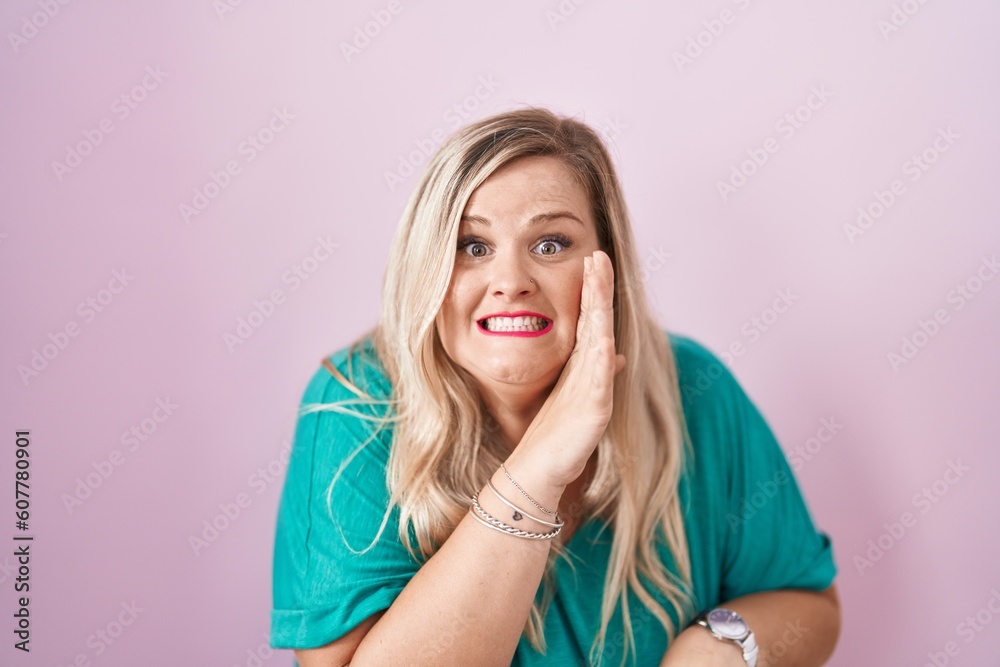 Caucasian plus size woman standing over pink background hand on mouth telling secret rumor, whispering malicious talk conversation Caucasian plus size woman standing over pink background hand on mouth telling secret rumor, whispering malicious talk conversation