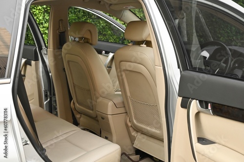 The rear passenger seat is wide and clean. Leather interior, side view, solar sunroof, buttons, Nappa leather, beige,black © chatchai