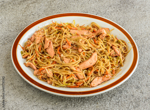chicken chowmein served in plate isolated on grey background top view of pakistani and indian spices food photo
