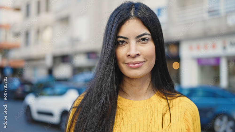 Young beautiful hispanic woman standing with relaxed expression at street Young beautiful hispanic woman standing with relaxed expression at street