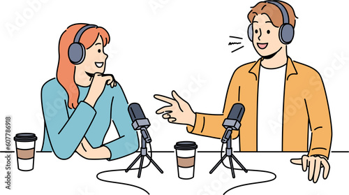 Smiling people talk in microphones on radio live