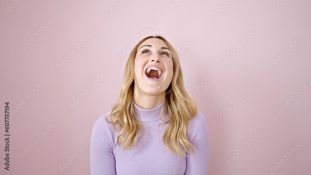 Young beautiful hispanic woman looking up with surprise expression over isolated pink background Young beautiful hispanic woman looking up with surprise expression over isolated pink background