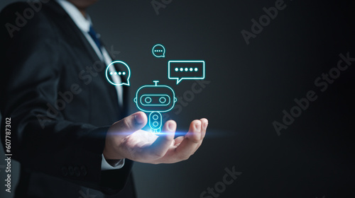 Chatbot. Ai. Robot. Businessman in suit holding a virtual model of artificial Intelligence. Using artificial Intelligence helps to work more efficiently.