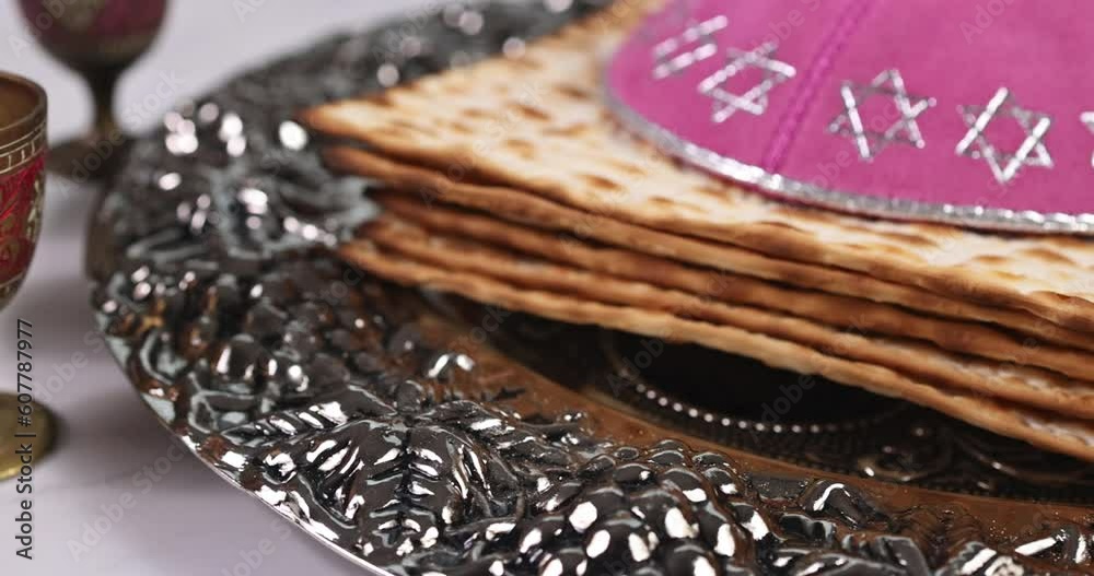 Jewish holiday Passover is kosher unleavened matzah bread and cup of kosher kiddush wine for Pesach