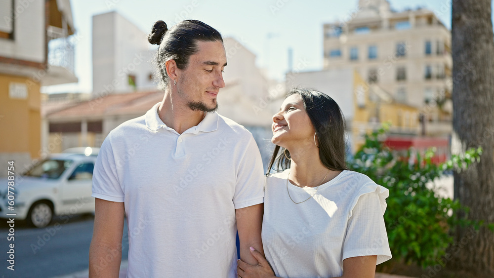 Man and woman couple smiling confident standing together at street Man and woman couple smiling confident standing together at street