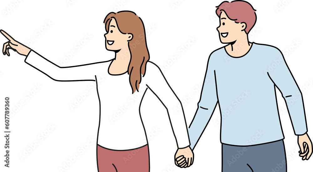 Smiling woman holding man by hand pointing forward Smiling woman holding man by hand pointing forward