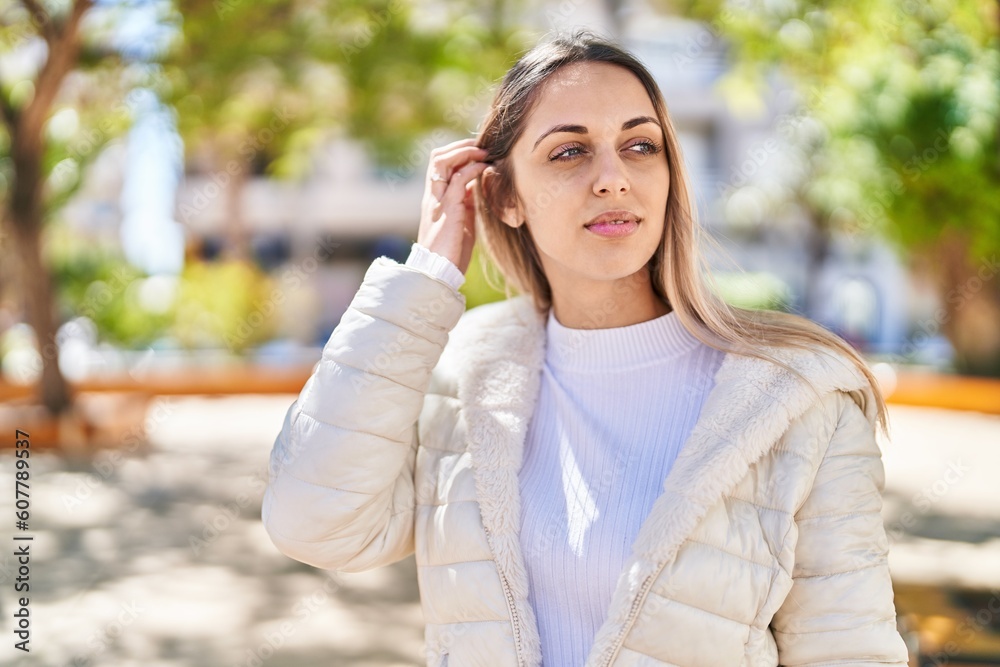 Young woman with relaxed expression standing at park Young woman with relaxed expression standing at park