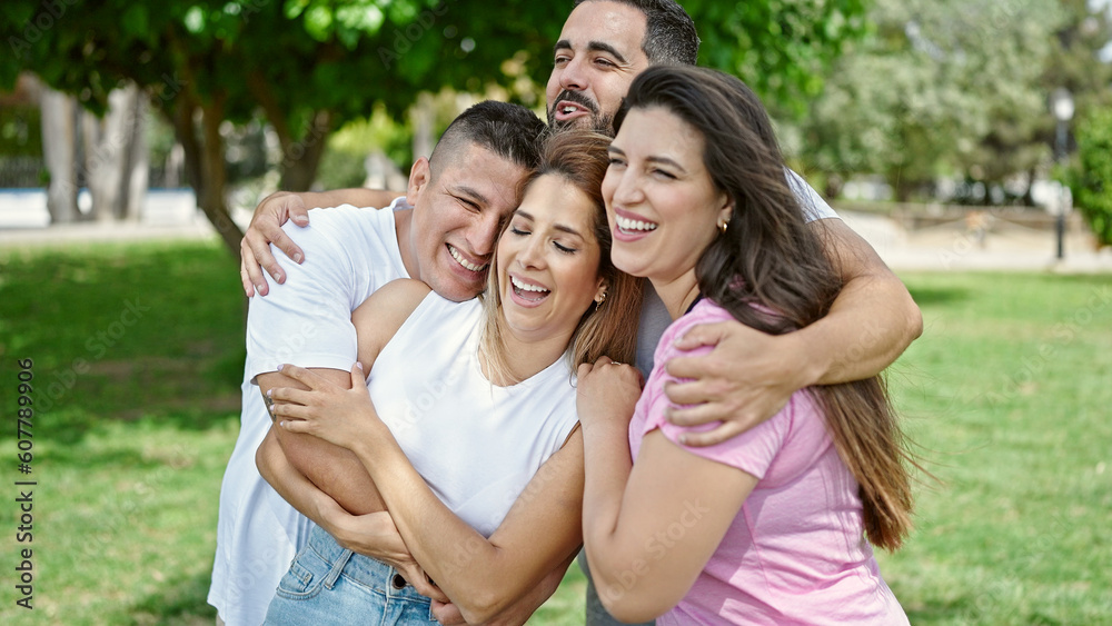 Fototapeta premium Group of people hugging each other smiling at park