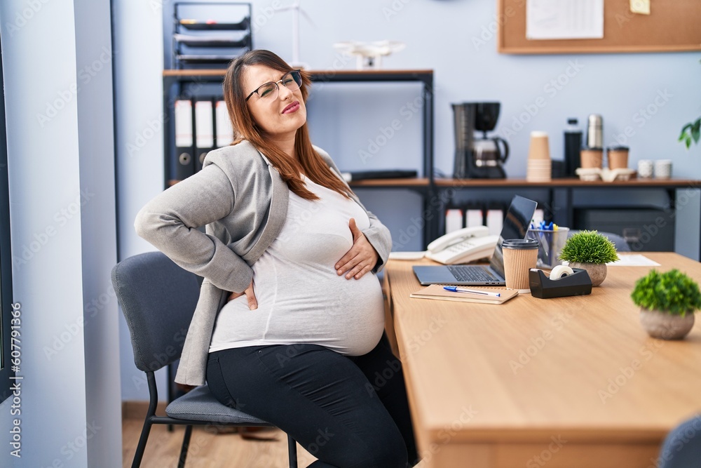 Young pregnant woman business worker suffering for backache at office Young pregnant woman business worker suffering for backache at office