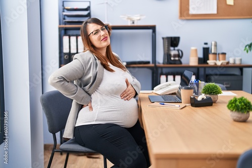 Young pregnant woman business worker suffering for backache at office