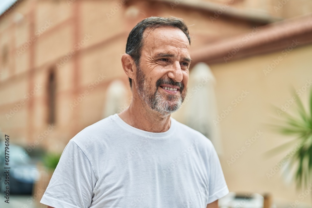 Fototapeta premium Middle age man smiling confident looking to the side at street
