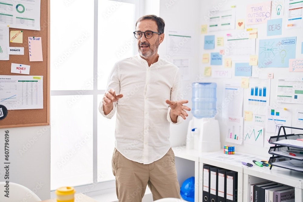 Middle age man business worker speaking at office Middle age man business worker speaking at office