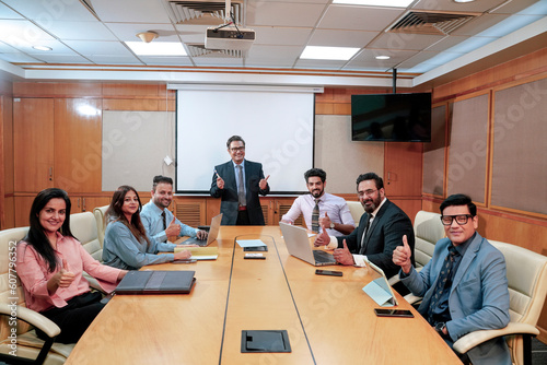 Indian business people showing thumps up at office