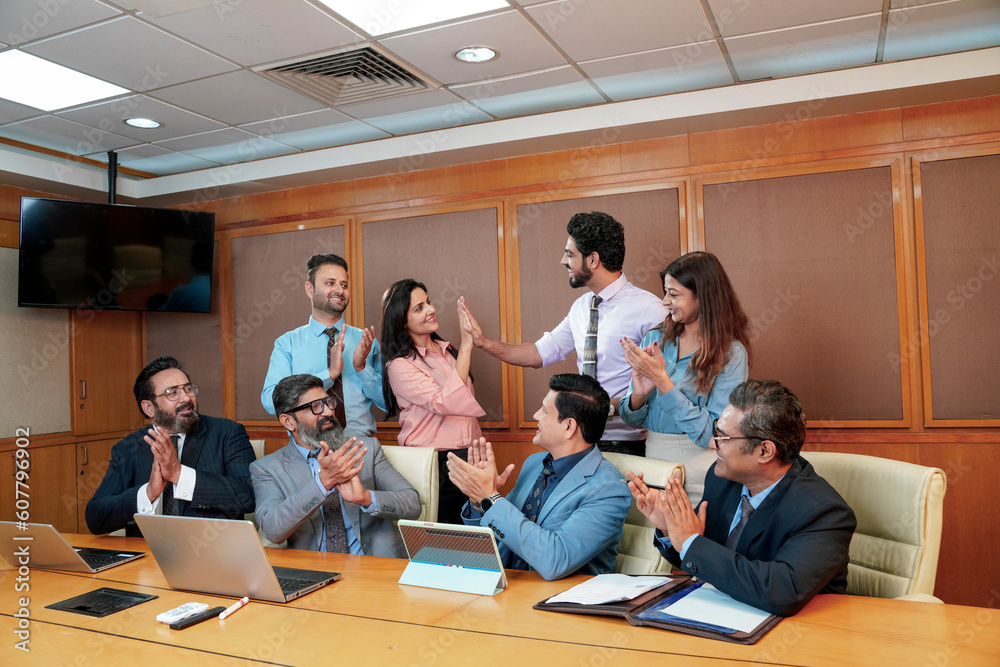 Indian businesspeople group celebrate after dealing feel happy and signing contract or agreement at meeting room Indian businesspeople group celebrate after dealing feel happy and signing contract or agreement at meeting room