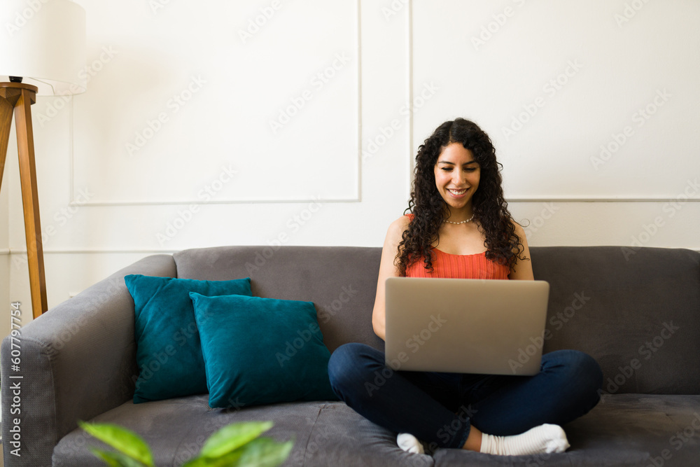 Young woman relaxing on the couch using the laptop Young woman relaxing on the couch using the laptop