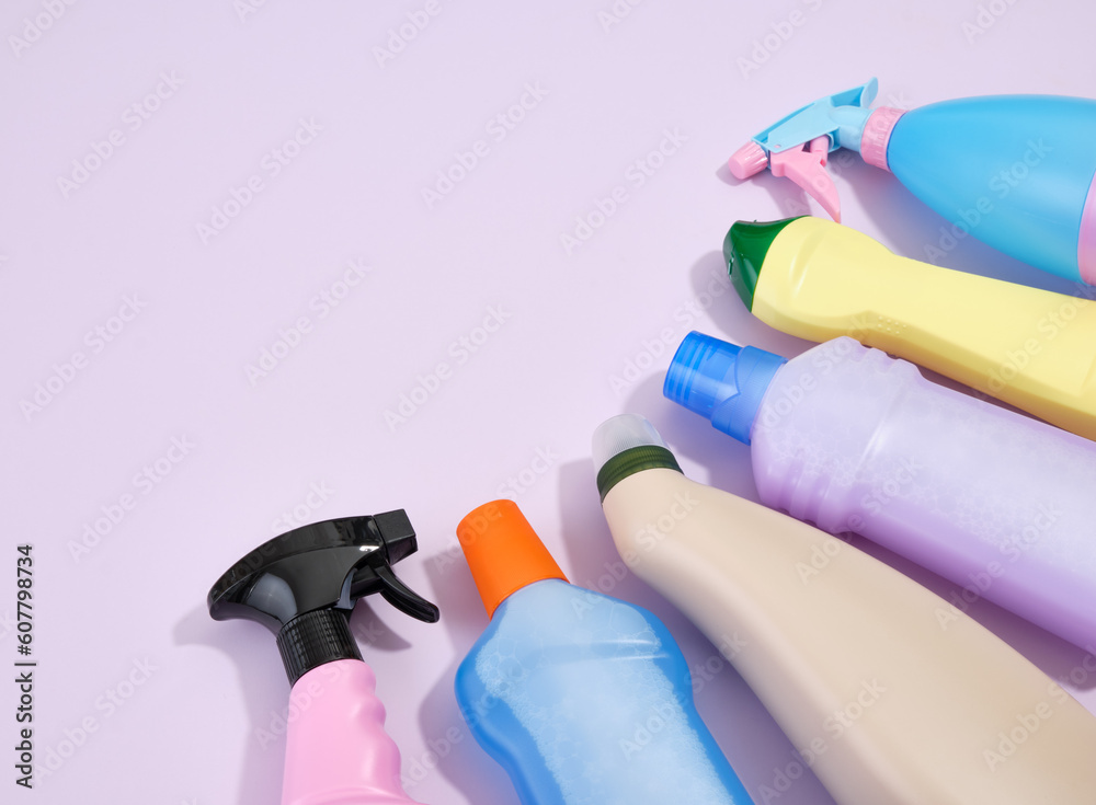 Different cleaning products on a purple background. Cleaning service concept. ?opy space for text. Different cleaning products on a purple background. Cleaning service concept. ?opy space for text.