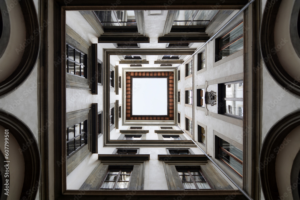 A view inside a square patio inside a block in Florence Italy, looking up A view inside a square patio inside a block in Florence Italy, looking up