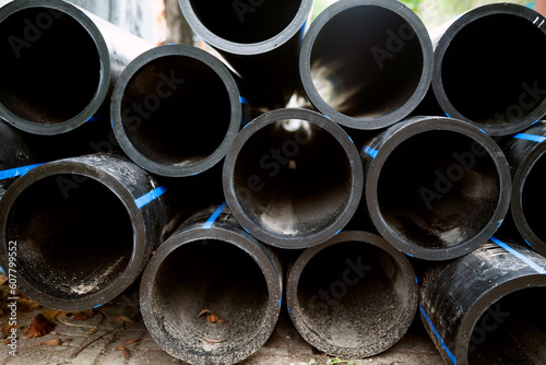 Vászonkép Pile of black HDPE pipes prepared for water transportation