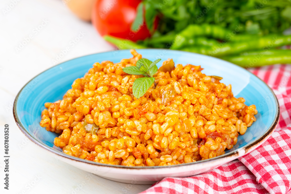 Traditional turkish bulgur pilaf with tomato sause in plate (Turkish name; meyhane pilavi) Traditional turkish bulgur pilaf with tomato sause in plate (Turkish name; meyhane pilavi)