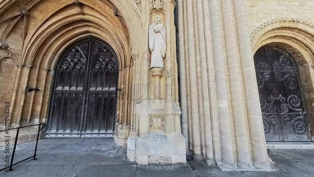 Push in shot towards the statue of Saint Benedict on the entrance to the medieval cathedral in the city of Norwich Push in shot towards the statue of Saint Benedict on the entrance to the medieval cathedral in the city of Norwich