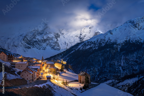 Ecrins National Park with the illuminated village of Le Chazelet and La Meije peak at night. Hautes-Alpes, French Alps, France