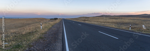 Fotografie Asphalt road going through the fields