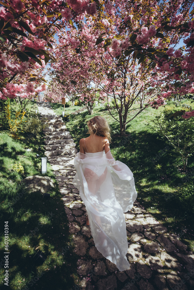 Beautiful woman runs in the garden. Bride with flowers. Beautiful woman runs in the garden. Bride with flowers.