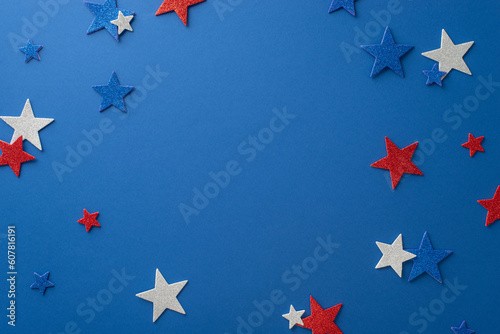 Capture the essence of Independence Day festivities with this top view: glittering stars, showcased on a blue backdrop with an open frame for text or advertising