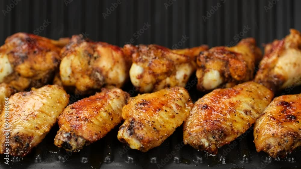 Fry chicken wings on grill, close up
