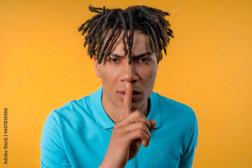 Handsome african man with gesture of shhh, secret, silence, conspiracy, gossip Handsome african man with gesture of shhh, secret, silence, conspiracy, gossip