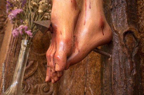 Feet of a crucified Christ pierced by a nail photo
