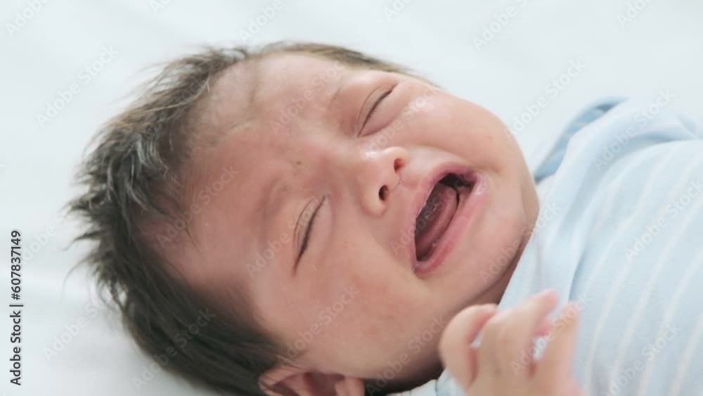 Adorable little baby lying on bed crying because he was hungry for milk,slow motion shot. Adorable little baby lying on bed crying because he was hungry for milk,slow motion shot.