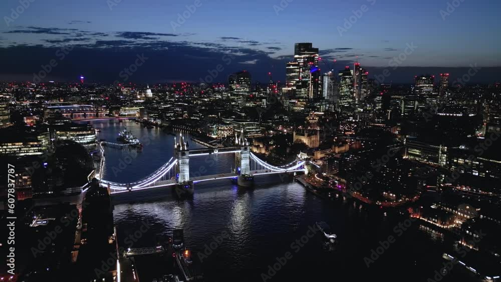 Aerial view of the illuminated Tower Bridge and skyline of London during night time