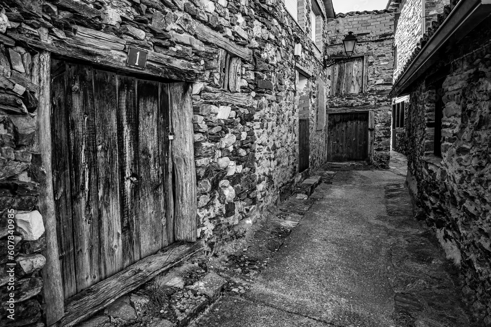 Old stone houses forming a narrow alley in an old village of Madrid, Puebla de la Sierra. Old stone houses forming a narrow alley in an old village of Madrid, Puebla de la Sierra.