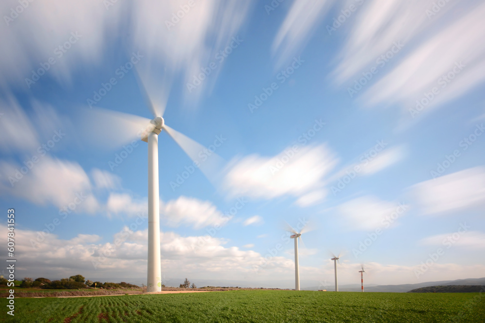 A group of wind turbine and a long exposure of a clouds A group of wind turbine and a long exposure of a clouds