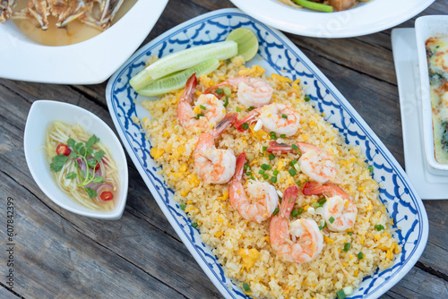 Closed up fried rice with egg and shrimps on wooden table as based menu in Chinese restaurant