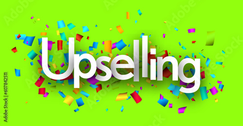 Upselling sign over colorful cut out ribbon confetti on green background. Design element. Vector illustration.