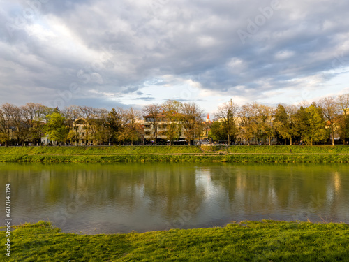 Amazing sunset landscape of the embankment of the river Uzh in Uzhhorod in the spring at the golden hour
