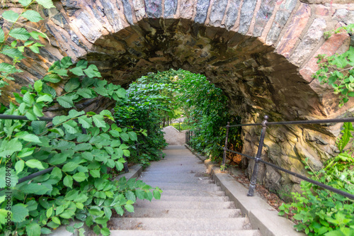 Narrow staircase going under an archway in Slottsskogen park in Gothenburg, Sweden