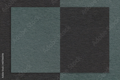 Texture of black and dark green and teal paper background with geometric shape and pattern, macro. Craft cardboard