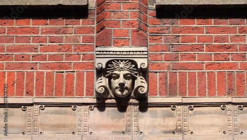 Amsterdam Warmoesstraat Street Sculpted Face Decoration on a Building Facade, Netherlands photo