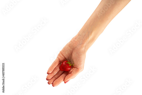 Strawberry in hand isolated on white background. Close up.