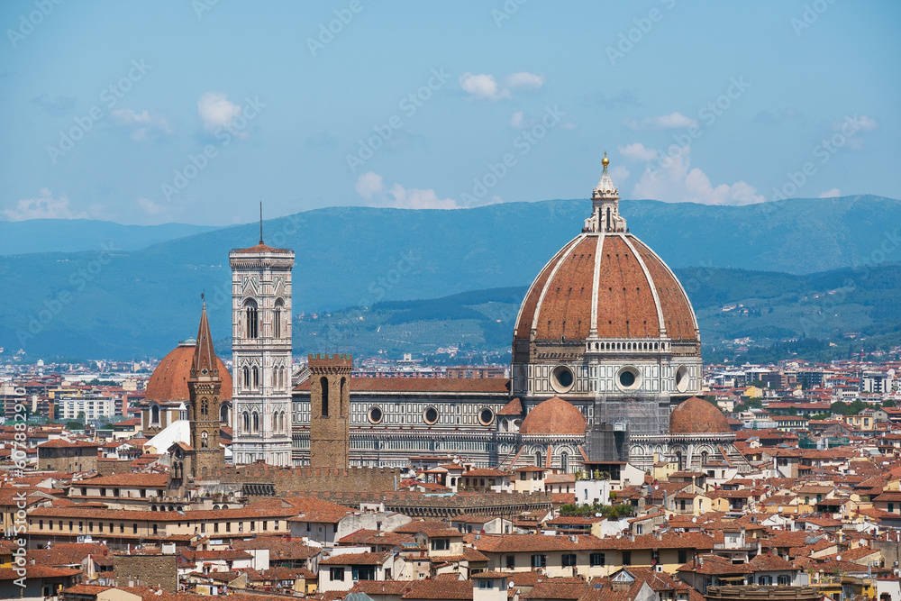 Santa Maria del Fiore with its huge Brunelleschi's dome and Giotto's Bell Tower lost in narrow old Florence city streets. Day view from Piazzale Michelangelo, Toscana, Italy.